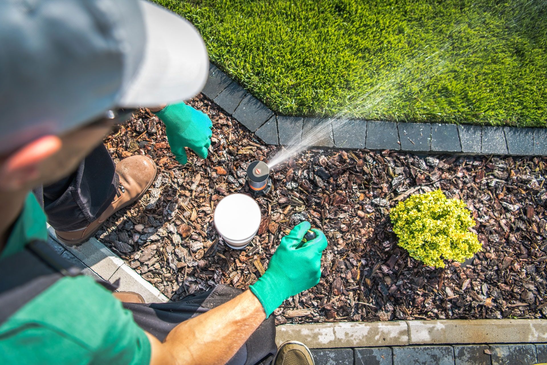 JG Landscape Management crew adjusting irrigation on a commercial property