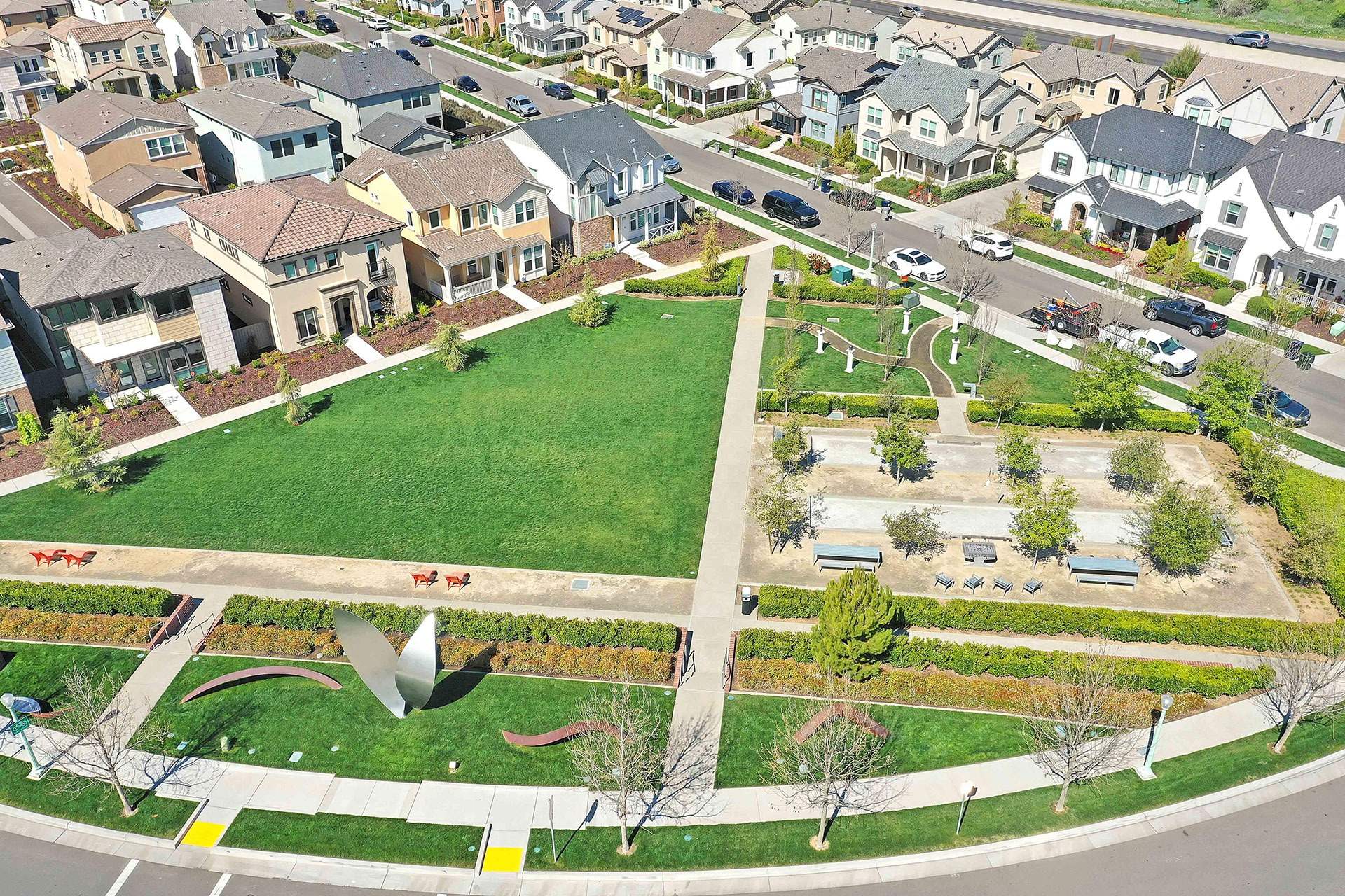 Aerial view of a maintained residential community landscape with walking paths